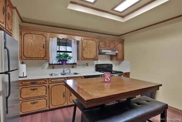 a room with furniture pool table kitchen view and living room view