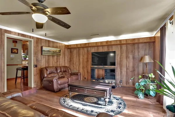 a living room with furniture a flat screen tv and a fireplace