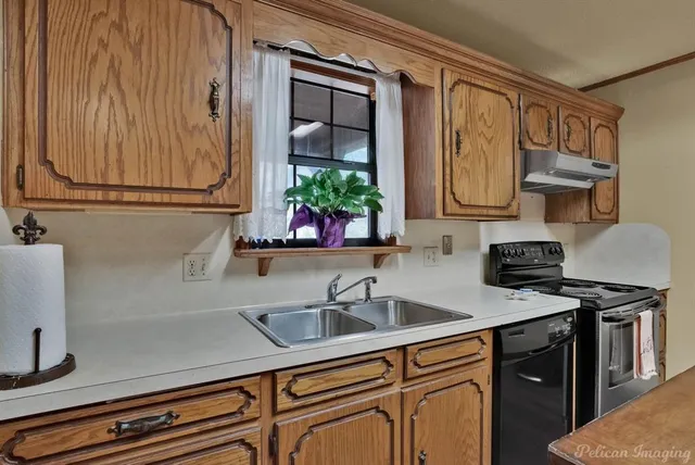 a kitchen with stainless steel appliances granite countertop a sink stove and cabinets