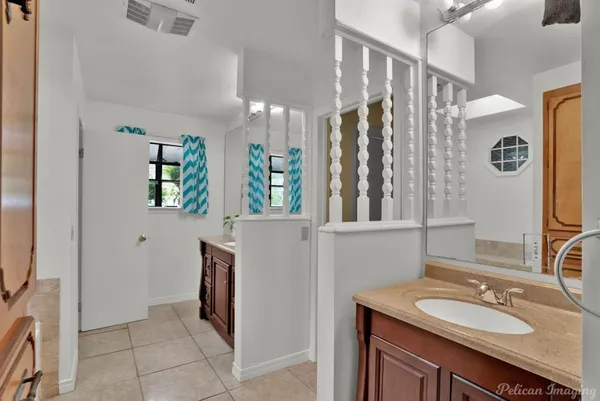 a bathroom with a granite countertop sink a mirror and shower