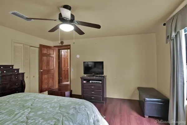 a bedroom with a bed and a television