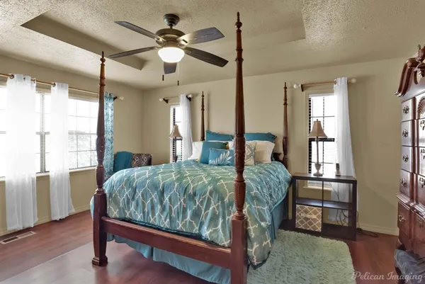 a bedroom with a bed mirror and window