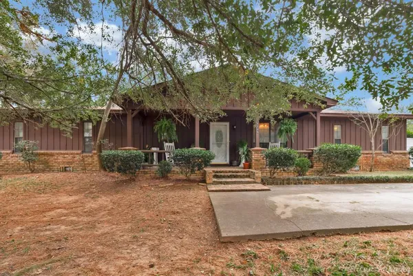 a view of house with outdoor space and sitting area