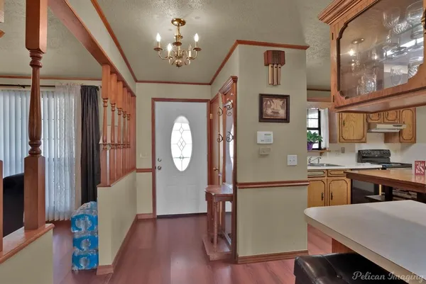 a kitchen with stainless steel appliances granite countertop a refrigerator a stove and a sink with dishwasher