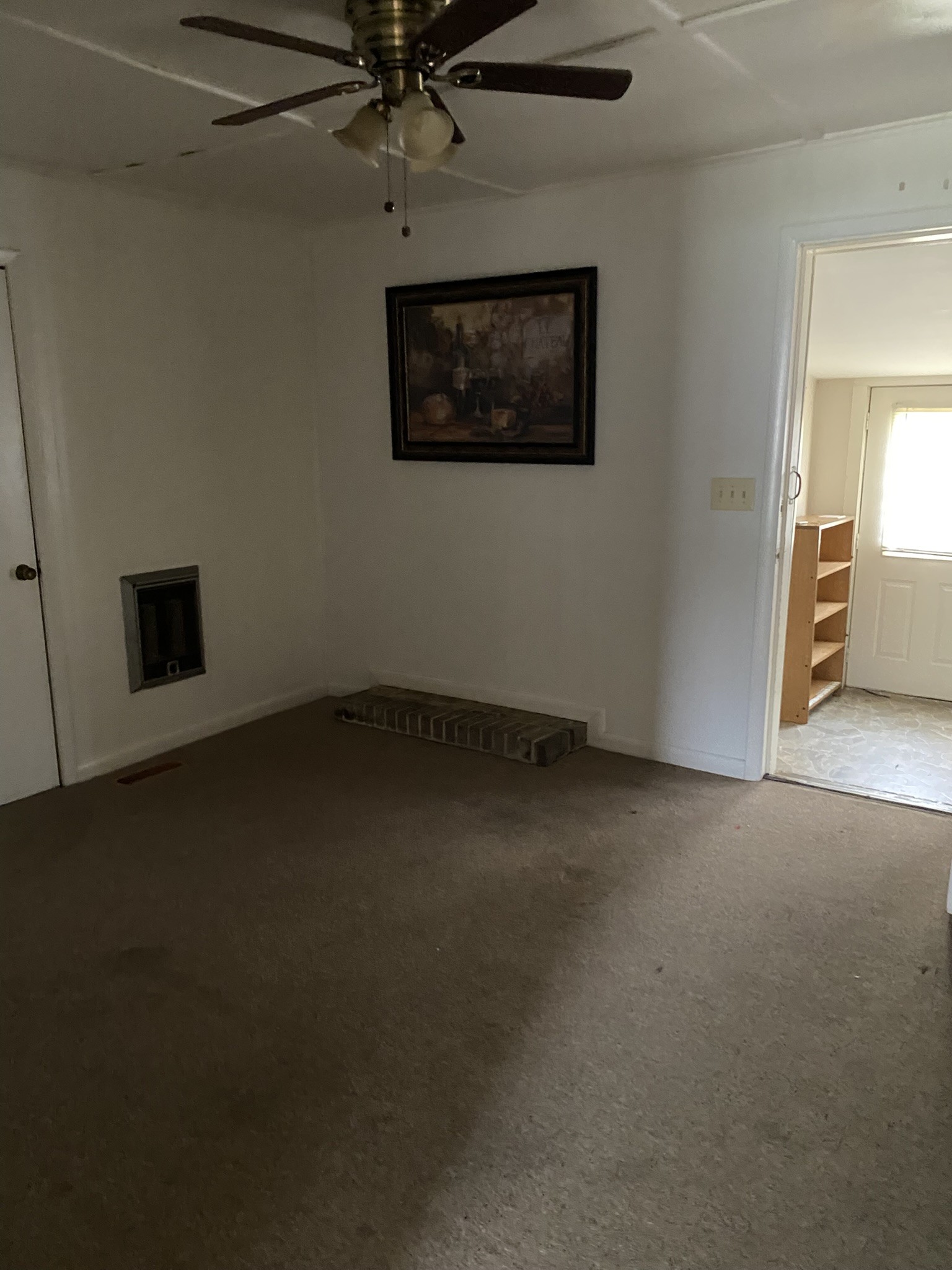 1035 North 3rd Street Pulaski, TN 38478 - Photo 7 of 17 an empty room with a ceiling fan and a window