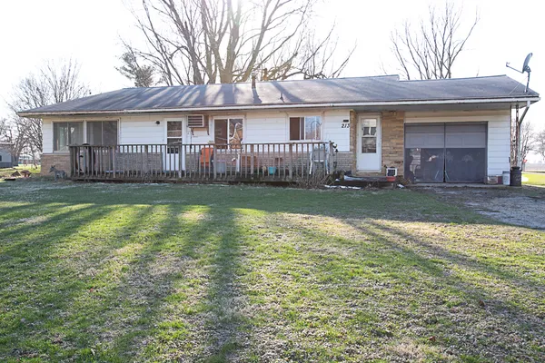 a view of a house with a yard and swimming pool