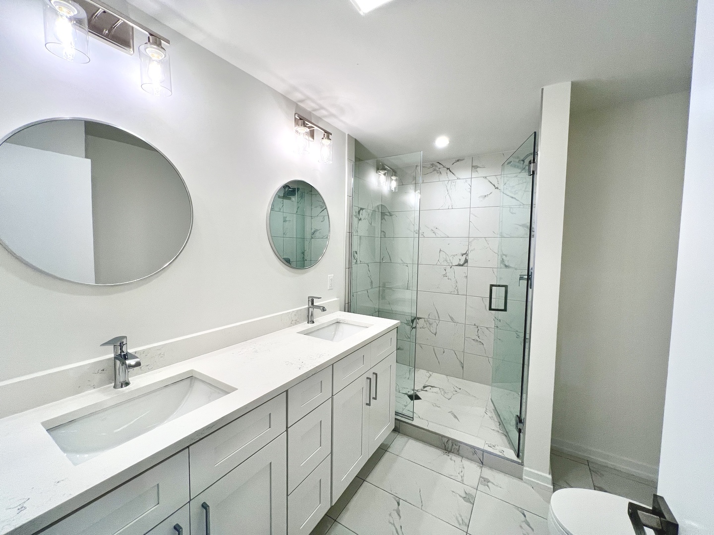 822 North Winchester Avenue, Unit 1F Chicago, IL 60622 - Photo 12 of 17 a bathroom with a double vanity sink mirror and shower