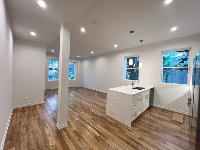 a view of kitchen with wooden floor and electronic appliances
