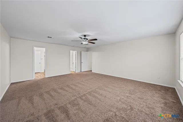 a view of a livingroom with a chandelier fan