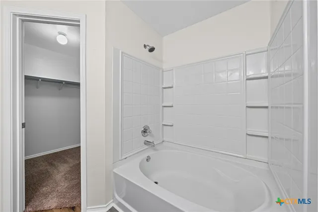 a white bath tub sitting in a bathroom