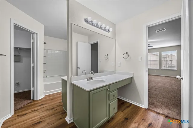 a bathroom with a sink a mirror and a shower