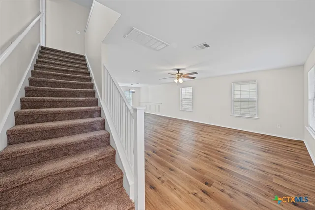 a view of entryway and hall with wooden floor