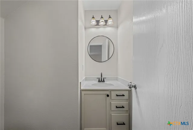 a bathroom with a sink and a vanity