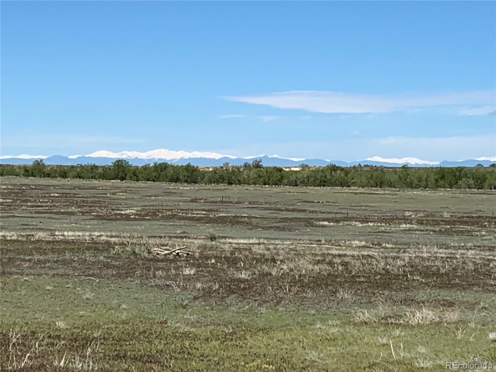 6955 Yulle Road Bennett, CO 80102 - Photo 16 of 16 a view of a lake with sunset in background