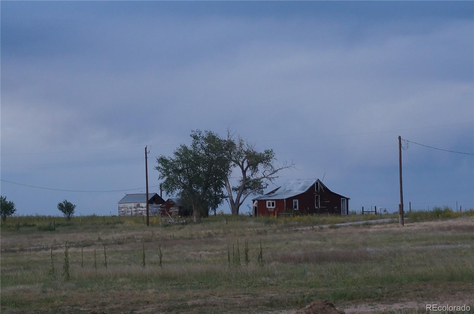 6955 Yulle Road Bennett, CO 80102 - Photo 3 of 16 a view of a house with a yard