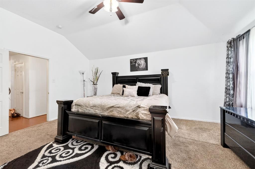 511 Chestnut Trail Forney, TX 75126 - Photo 22 of 32 Vaulted ceiling bedroom featuring carpeting, a ceiling fan with light fixture, and double doors