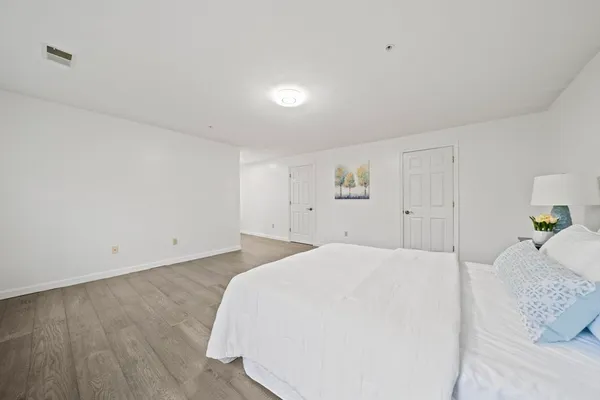 a bedroom with a bed and a night stand