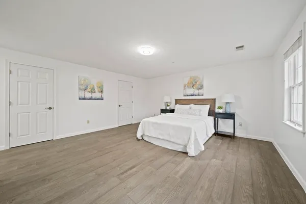 a bedroom with a bed and a window