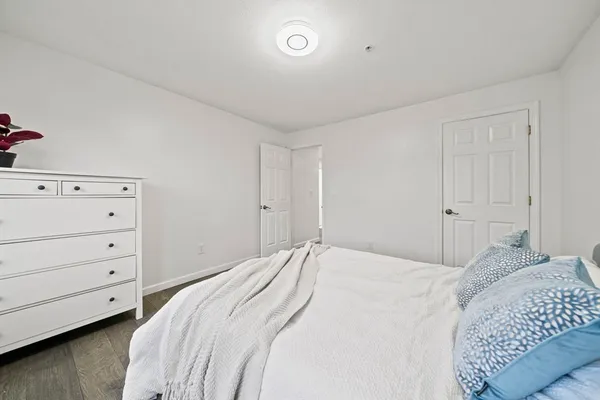 a bedroom with a bed and a dresser