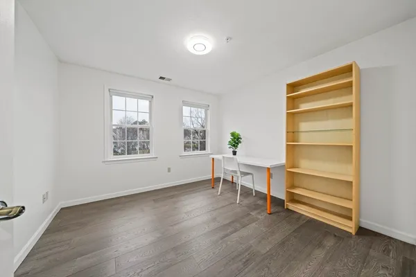 a view of room with wooden floor and window