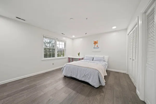 a spacious bedroom with a bed and a window