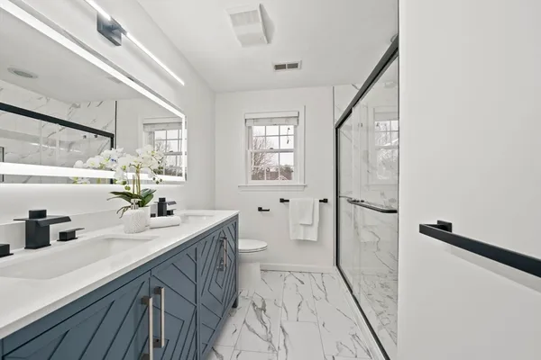 a bathroom with a sink a mirror and a shower