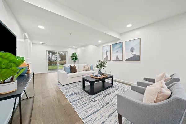 a living room with furniture and a potted plant