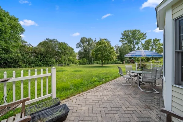 a view of a chair and table on the garden