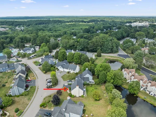 an aerial view of a house with a yard and lake view