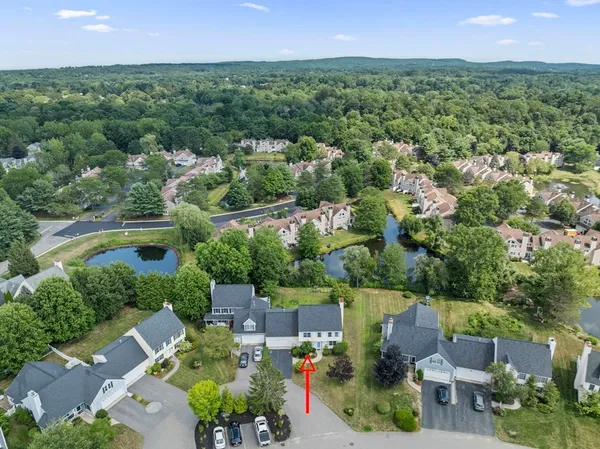 an aerial view of residential houses with outdoor space and street view