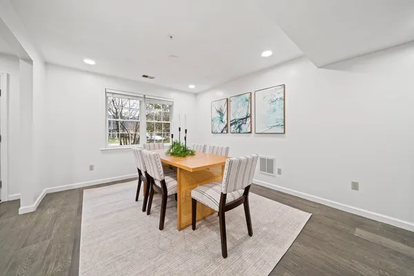 a view of a dining room with furniture and wooden floor