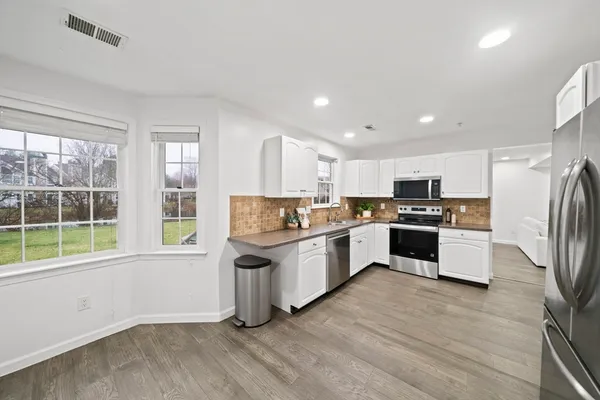 a kitchen with stainless steel appliances a refrigerator sink and stove