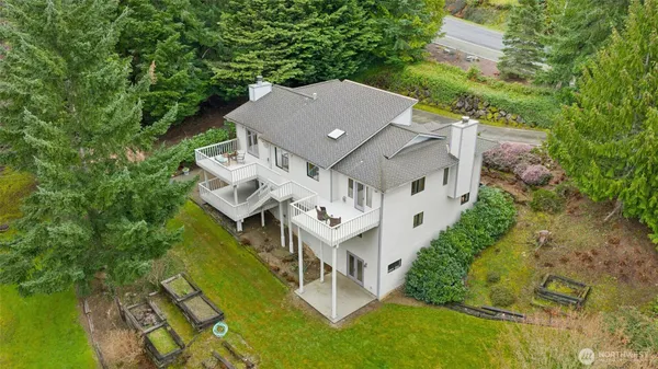 an aerial view of a house with a big yard