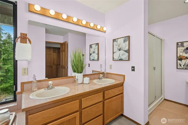 a bathroom with a granite countertop sink and a mirror