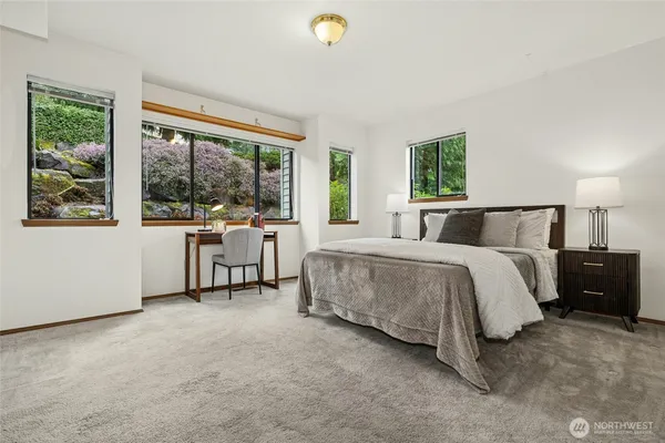 a bedroom with a bed and a large window