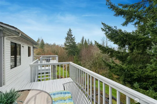 a view of a balcony with wooden floor and fence