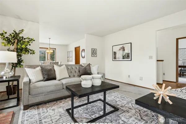a living room with furniture and a potted plant