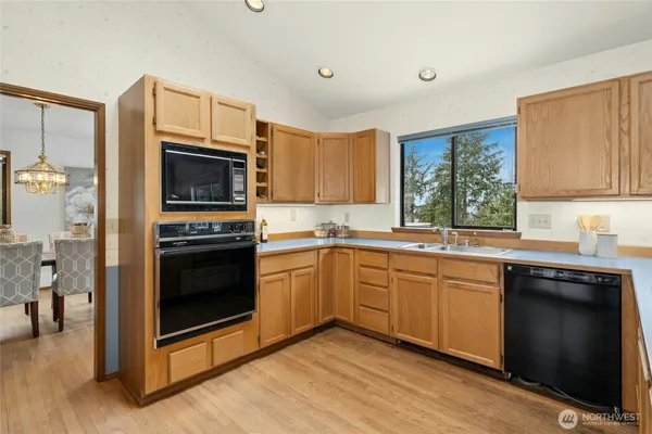 a kitchen with a sink stove and microwave