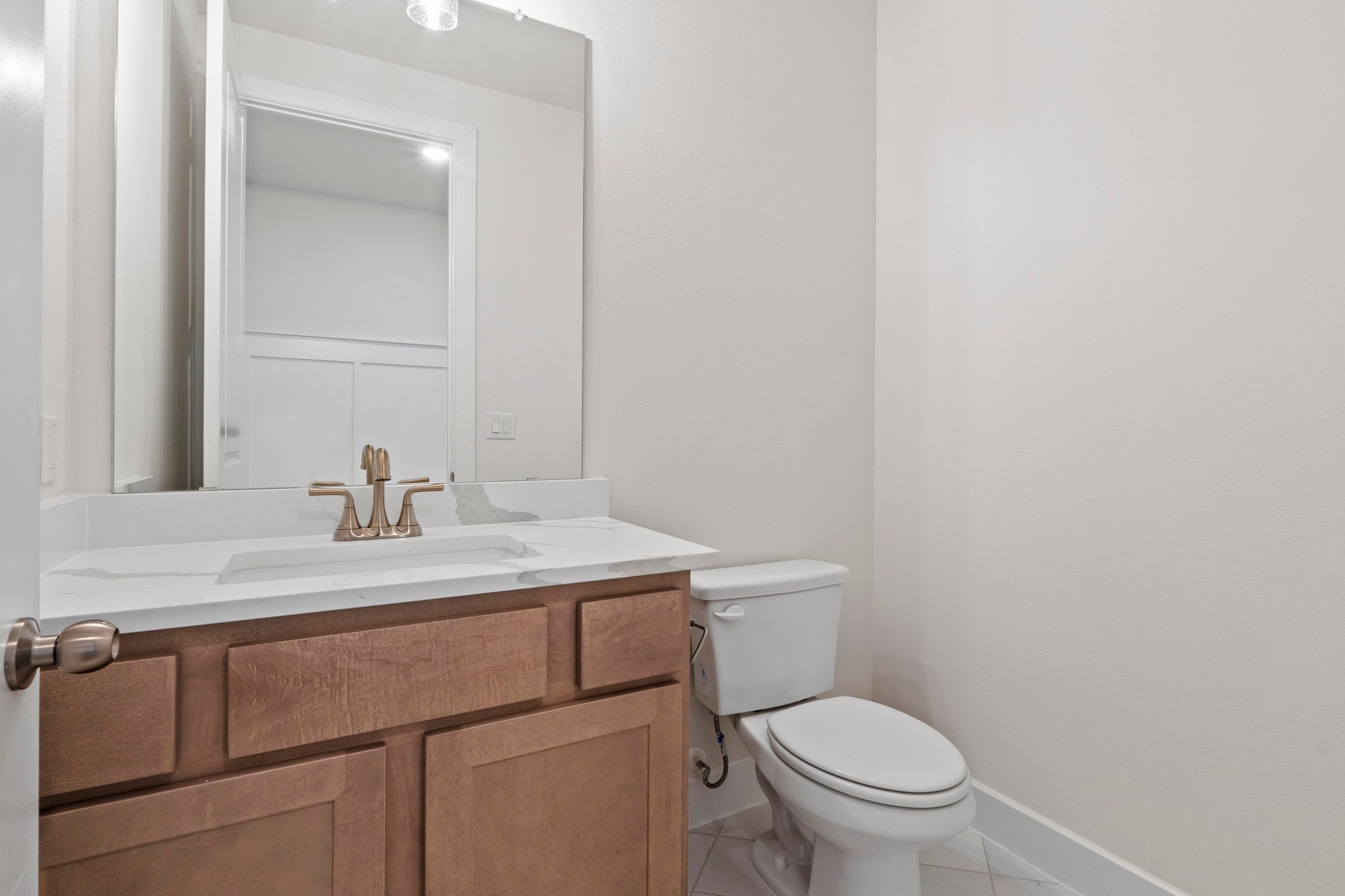 604 Lightstone Drive Georgetown, TX 78633 - Photo 29 of 39 a bathroom with a granite countertop toilet sink and mirror