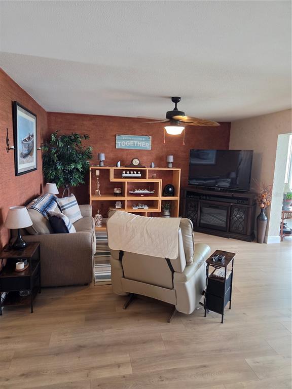 7 Dunoon Place, Unit 309 Dunedin, FL 34698 - Photo 12 of 25 a living room with furniture and a piano