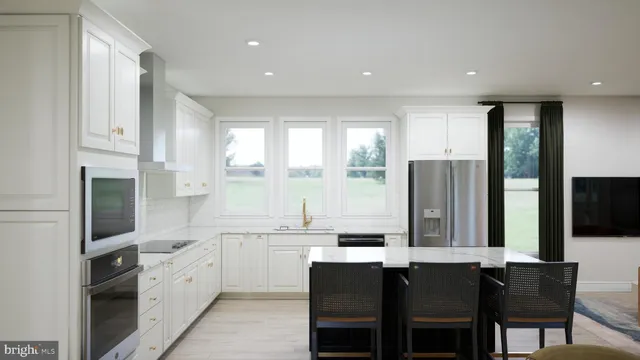 a kitchen with stainless steel appliances granite countertop a stove a sink dishwasher a refrigerator and a dining table with wooden cabinet