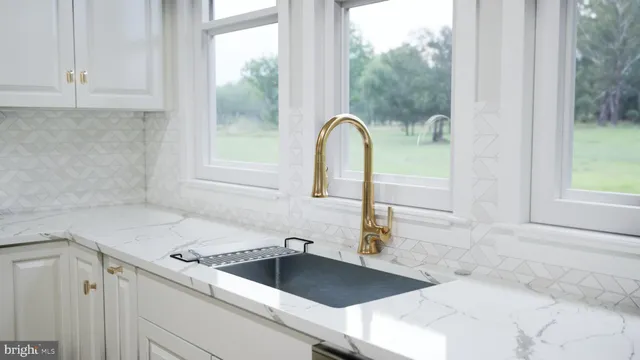 a kitchen with a sink and large window