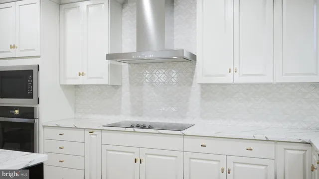 a kitchen with white cabinets and a stove