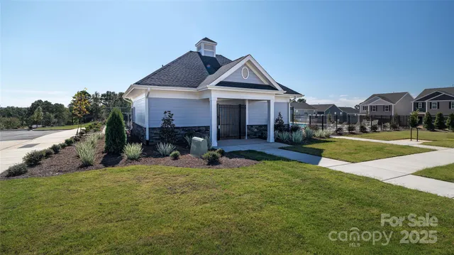 a swimming pool with outdoor seating and yard
