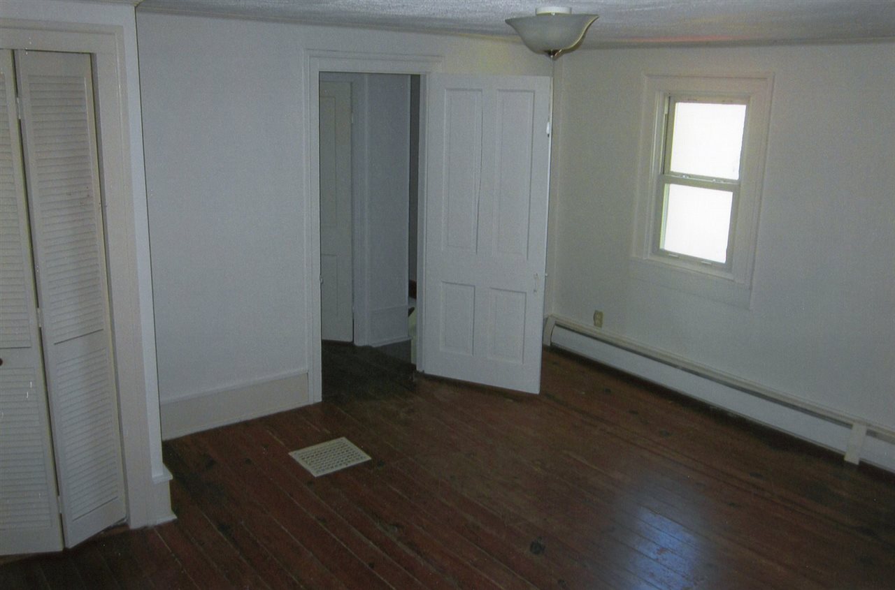 4940 Spring Hill Road Mount Solon, VA 22843 - Photo 20 of 44 an empty room with wooden floor and windows