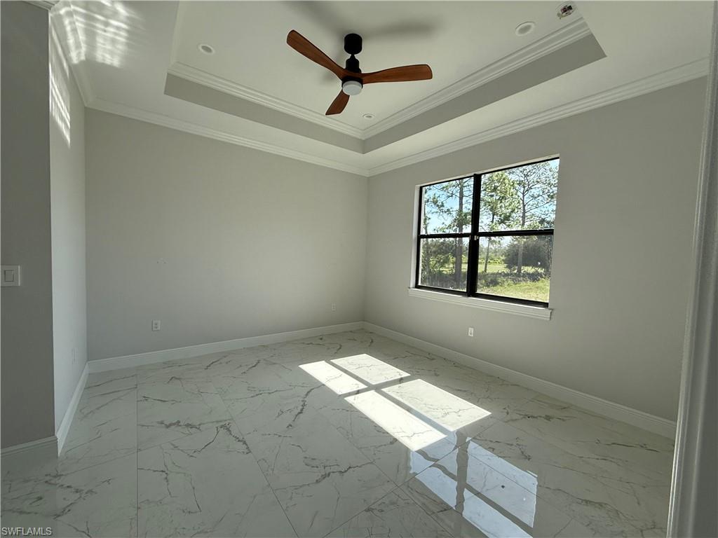 4768 40th Street Northeast Naples, FL 34120 - Photo 9 of 18 Spacious room featuring tray ceiling with crown molding, recessed lighting, and a ceiling fan