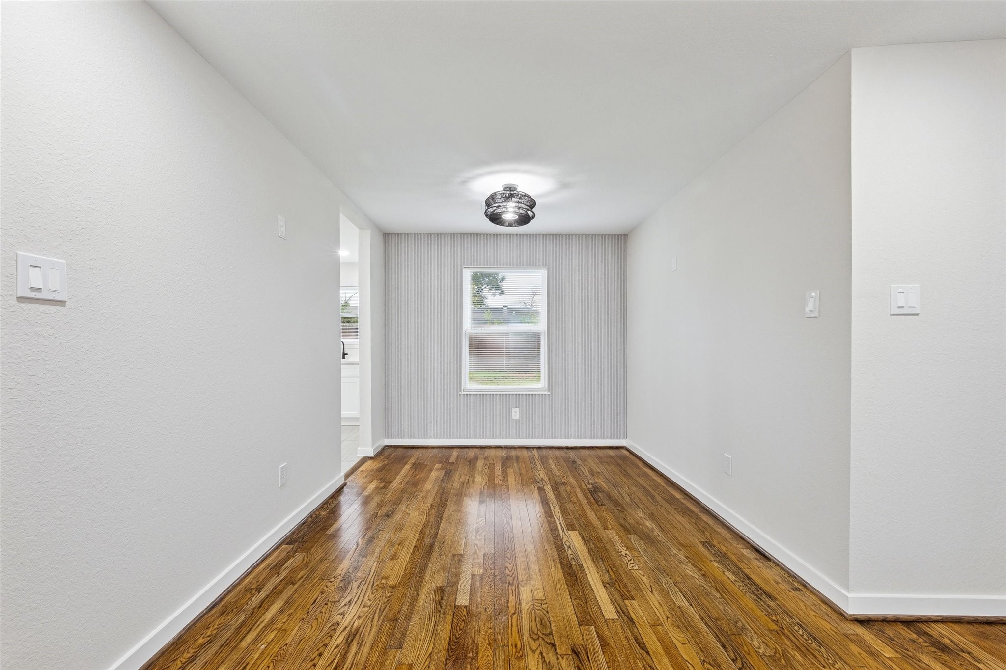 6731 London Street Houston, TX 77021 - Photo 4 of 11 a view of an empty room with wooden floor and a window
