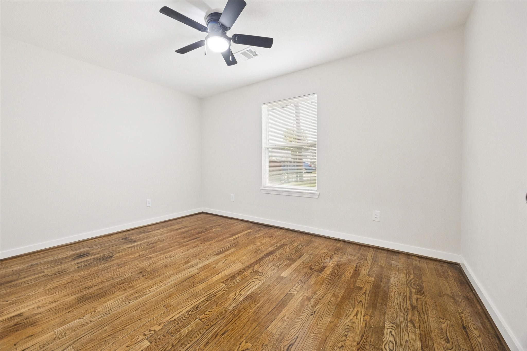6731 London Street Houston, TX 77021 - Photo 6 of 11 wooden floor in an empty room with a window