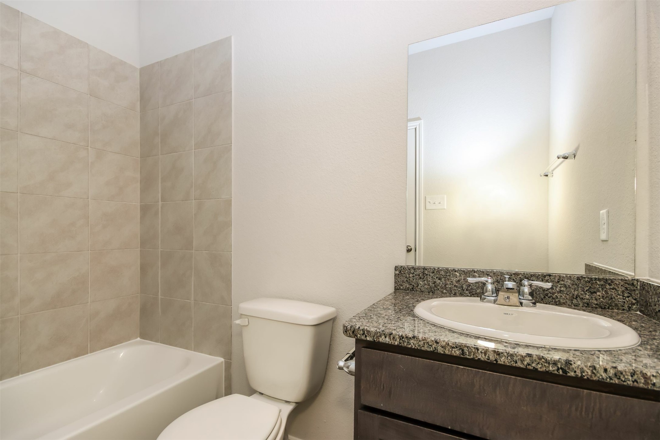 15226 Estrella Road West Houston, TX 77073 - Photo 13 of 13 a bathroom with a granite countertop sink and a mirror