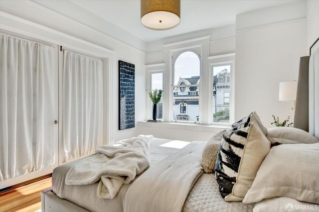 a bedroom with bed and a chandelier